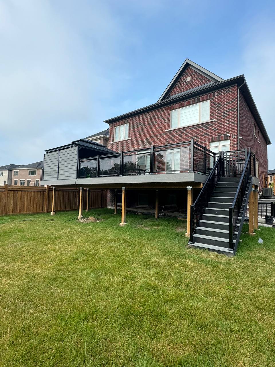 Elevated composite deck with glass and aluminum railing