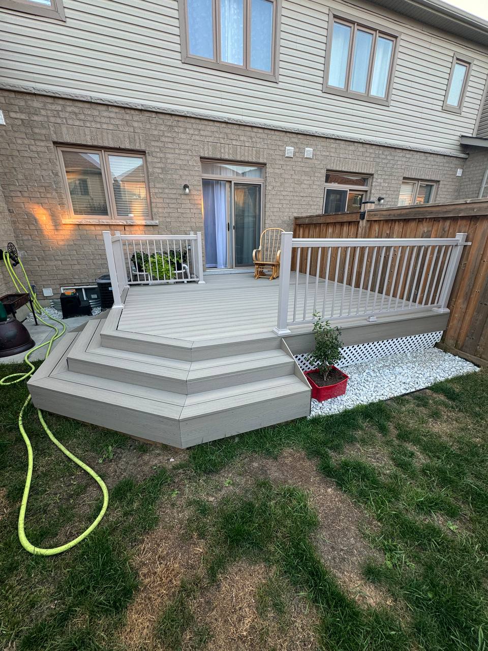 Composite deck with white railing and wraparound steps